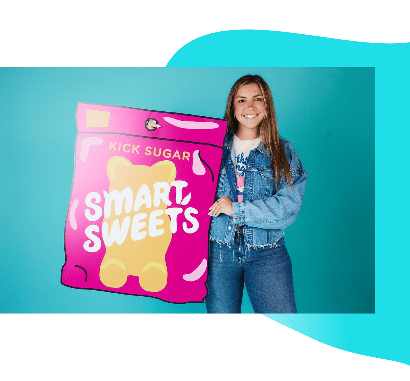 Woman holding SmartSweets pouch cardboard cutout