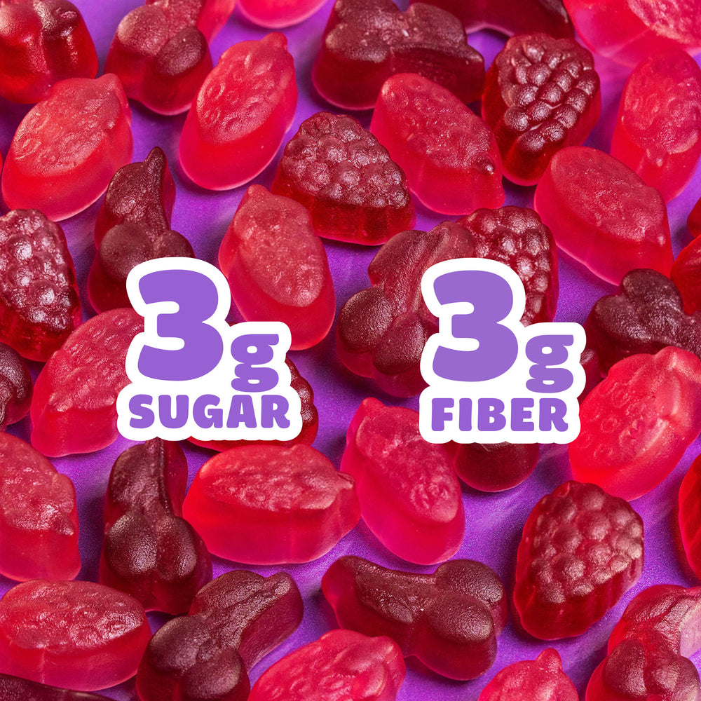 Assorted fruit gummies on green background. Text: 3g SUGAR, 3g FIBER.