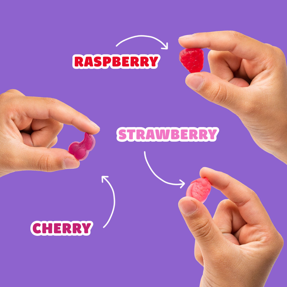 Hands holding fruit gummies. Text: RASPBERY, STRAWBERRY, CHERRY
