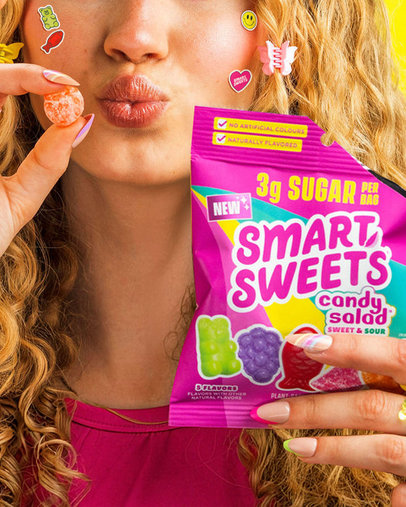 Woman holding NEW! Candy Salad bag: 3g SUGAR, SWEET & SOUR.