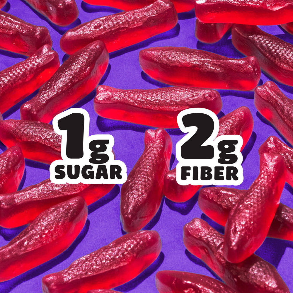 Red fish gummy candies on a purple background. Text: 1g SUGAR, 2g FIBER.